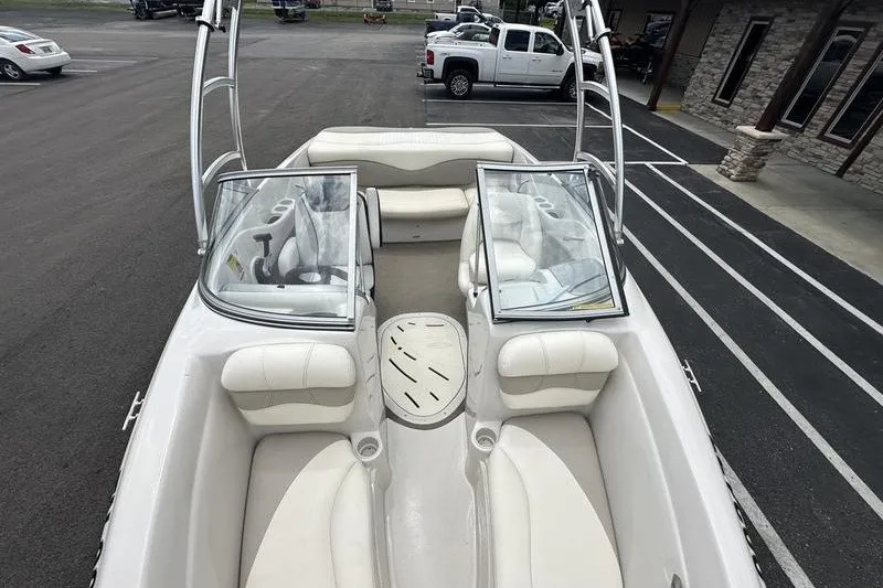 Slide: The Image of 2008 Tahoe Q6 Sport boat interior with white seating and open windshield. - 21