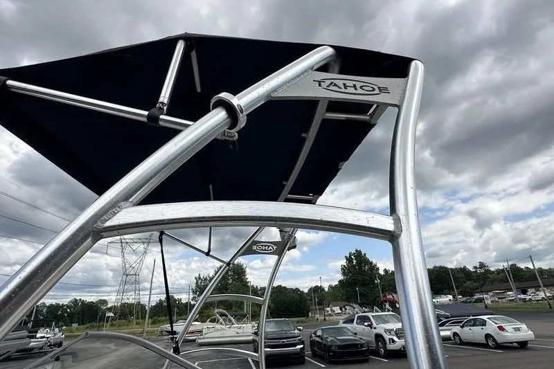 Slide: The Image of 2008 Tahoe Q6 Sport boat with canopy, parked under cloudy sky. - 18