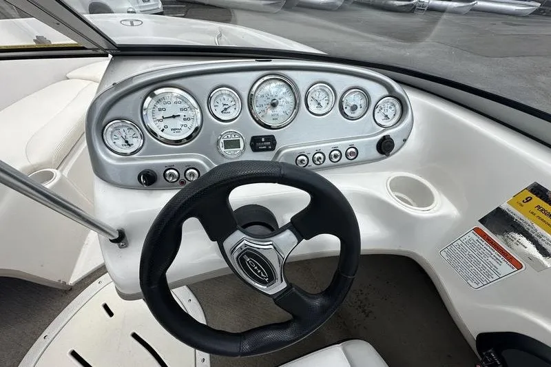 Slide: The Image of Steering wheel and dashboard of a 2008 Tahoe Q6 Sport boat, featuring multiple gauges. - 17