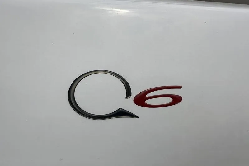 Slide: The Image of 2008 Tahoe Q6 Sport emblem on white surface, featuring sleek black and red design. - 10
