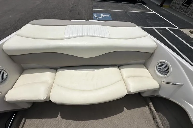 Slide: The Image of 2008 Tahoe Q6 Sport boat interior with white cushioned seating and speaker detail. - 12