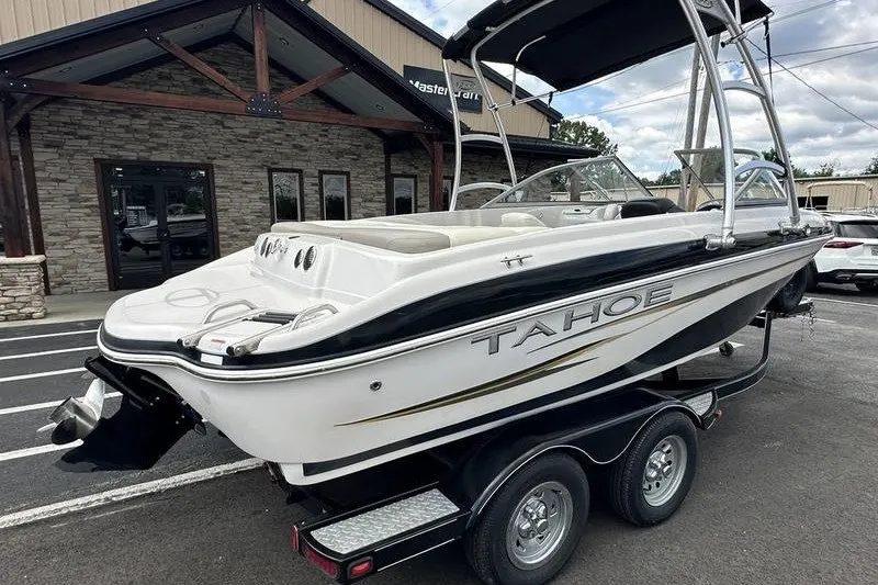 Slide: The Image of 2008 Tahoe Q6 Sport boat on trailer, parked outside a building. - 11