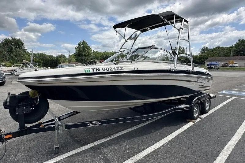 Slide: The Image of 2008 Tahoe Q6 Sport boat on trailer in parking lot under cloudy sky. - 6