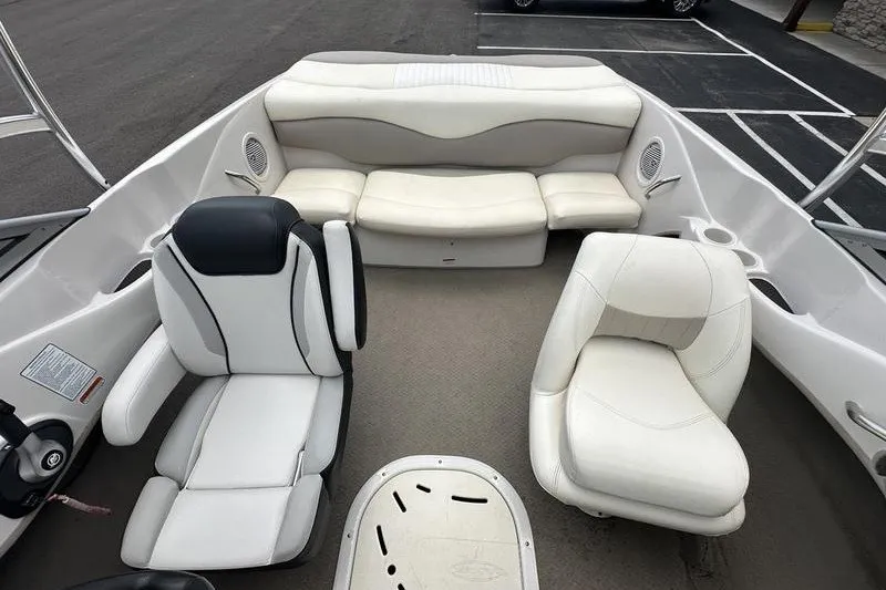 Slide: The Image of 2008 Tahoe Q6 Sport boat interior with white seating and steering wheel. - 14