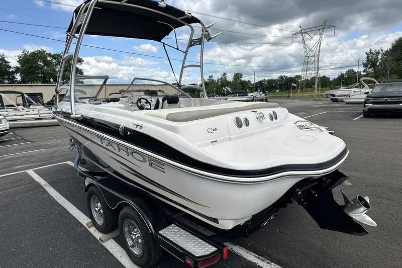 Slide: The Image of 2008 Tahoe Q6 Sport boat on trailer in parking lot, under cloudy sky. - 5