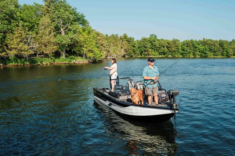 Slide: The Image of Two people fishing on a 2027 Crestliner 1850 Fish Hawk WT boat with a dog. - 3