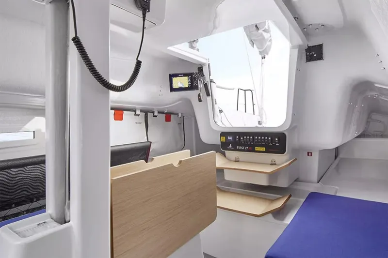 Slide: The Image of Manufacturer Provided Image: Interior of 2026 Beneteau First 27 SE sailboat, featuring modern navigation equipment and seating. - 3
