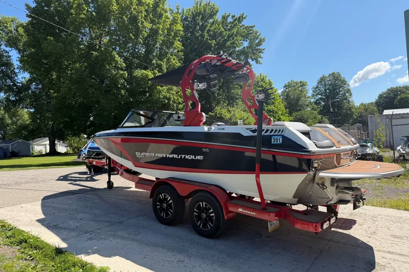 Slide: The Image of 2020 Nautique Super Air Nautique GS20 boat on trailer, parked outdoors on a sunny day. - 4