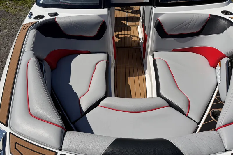 Slide: The Image of 2020 Nautique Super Air Nautique GS20 boat interior with stylish seating and wood accents. - 7