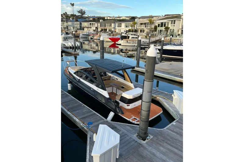Slide: The Image of Luxury Hanover 305 boat docked at marina, 2026 model, sleek design. - 2