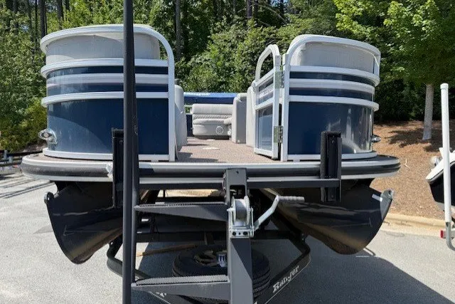 Slide: The Image of 2019 Ranger Reata 200C pontoon boat on trailer, parked outdoors. - 9