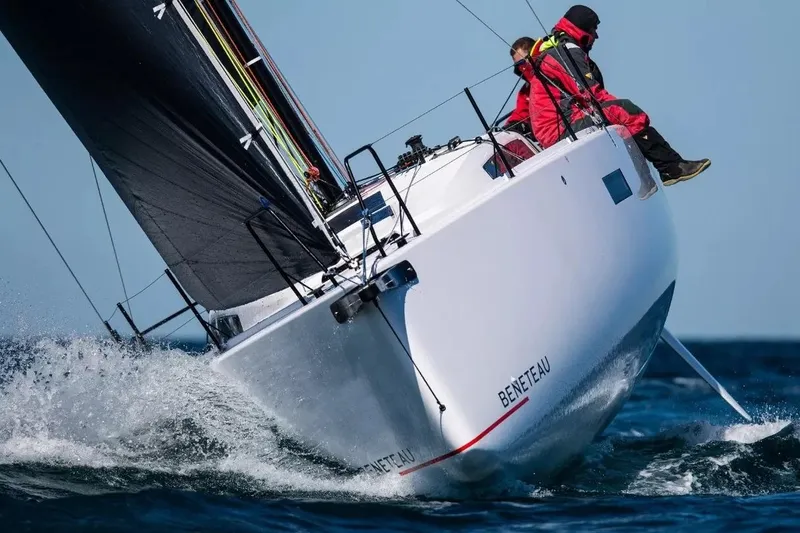 The Image of Manufacturer Provided Image: 2026 Beneteau FIRST 36 SE sailboat navigating ocean waves with crew in red jackets. - 0
