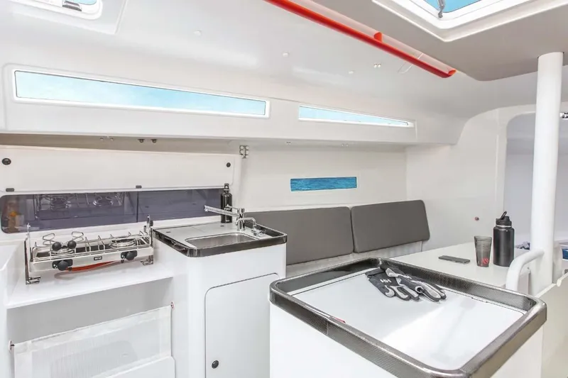 Slide: The Image of Manufacturer Provided Image: Interior of 2026 Beneteau FIRST 36 SE yacht, featuring modern kitchen and seating area. - 5