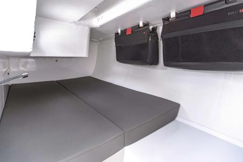 Slide: The Image of Manufacturer Provided Image: 2026 Beneteau FIRST 36 SE interior cabin with sleek storage and comfortable seating. - 7