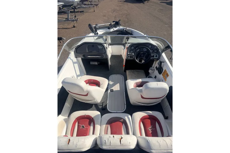 Slide: The Image of 2002 Nitro 175 Sport boat interior with white and red seating, steering console, and dashboard. - 8