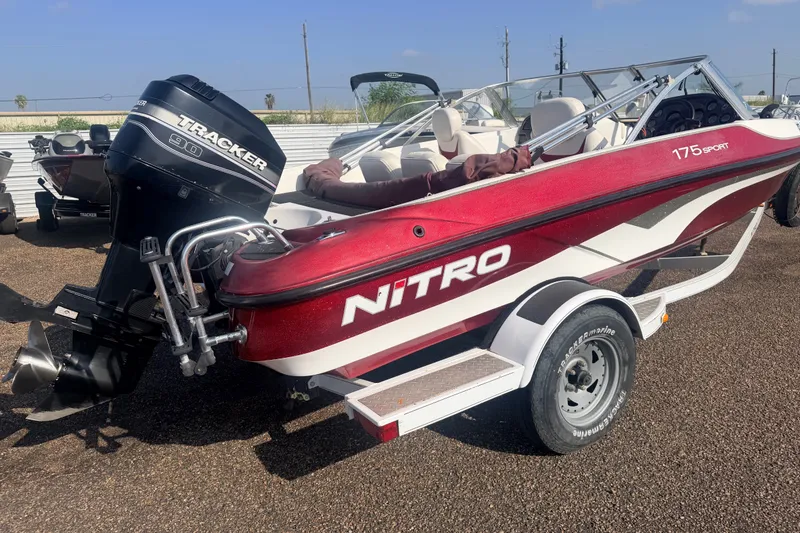 Slide: The Image of 2002 Nitro 175 Sport boat with Tracker 90 engine on trailer, parked outdoors. - 5