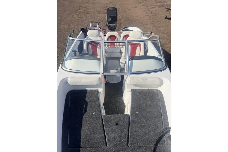 Slide: The Image of 2002 Nitro 175 Sport boat interior with red and white seating, windshield, and motor. - 12