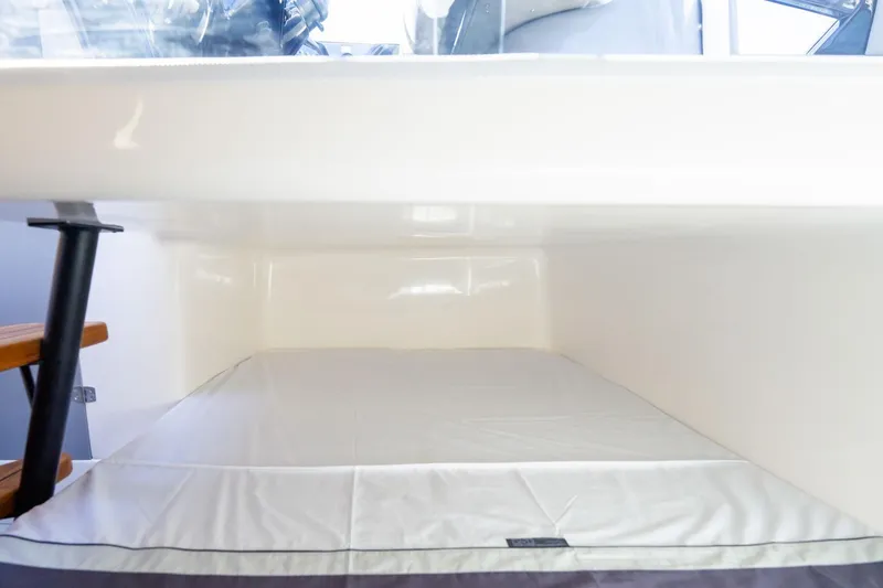 Slide: The Image of Interior cabin of 2026 Hanover 305 boat with white bedding. - 11