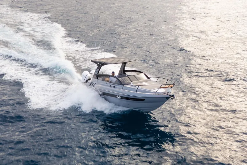 Slide: The Image of 2026 Hanover 305 boat cruising on open water, creating a dynamic wake. - 7