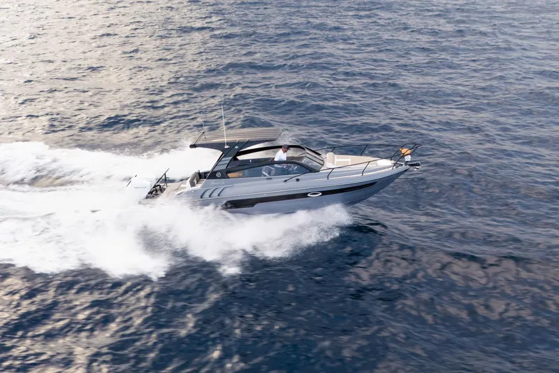 Slide: The Image of 2026 Hanover 305 boat cruising on open water, creating a dynamic wake. - 1