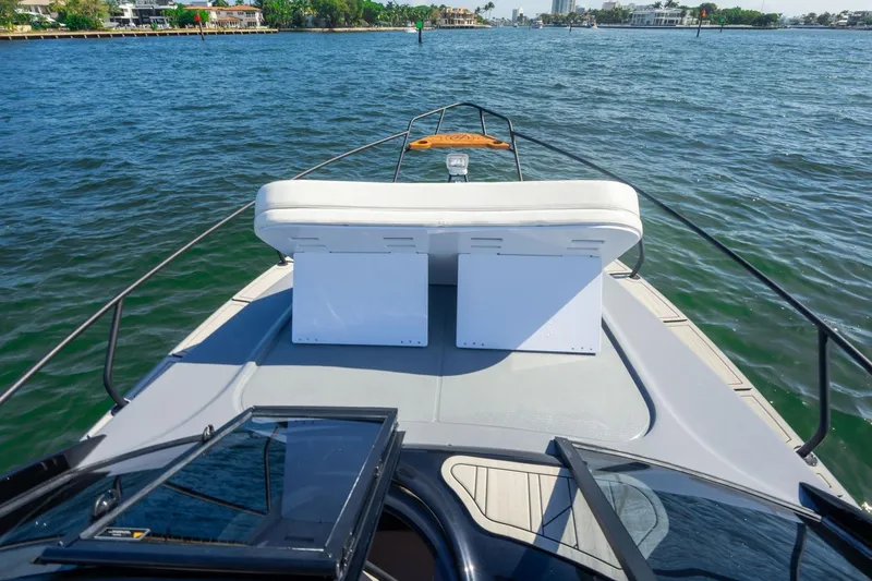 Slide: The Image of 2026 Hanover 305 boat deck with seating, cruising on a sunny day. - 23