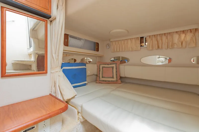 Slide: The Image of 2001 Sea Ray Sundancer 310 cabin interior with cozy bed and mirror. - 23