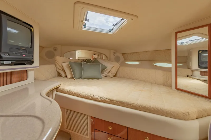 Slide: The Image of Luxurious interior cabin of 2001 Sea Ray Sundancer 310 yacht with cozy bedding and TV. - 31