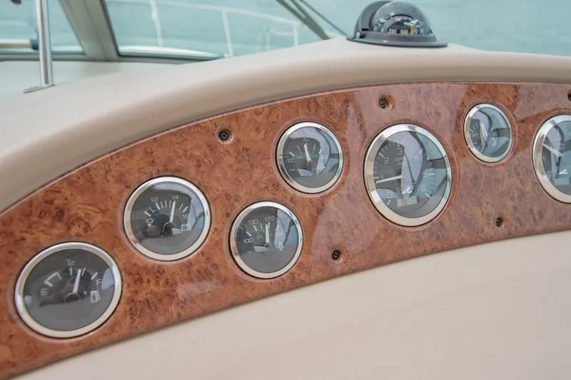 Slide: The Image of Dashboard of a 2001 Sea Ray Sundancer 310 with wood paneling and gauges. - 21