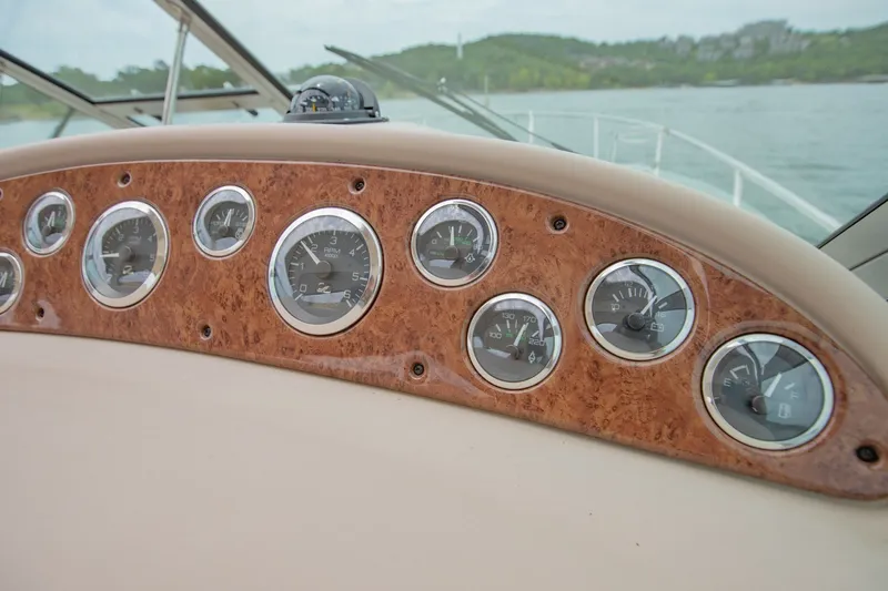 Slide: The Image of Dashboard of a 2001 Sea Ray Sundancer 310 boat with multiple gauges. - 22