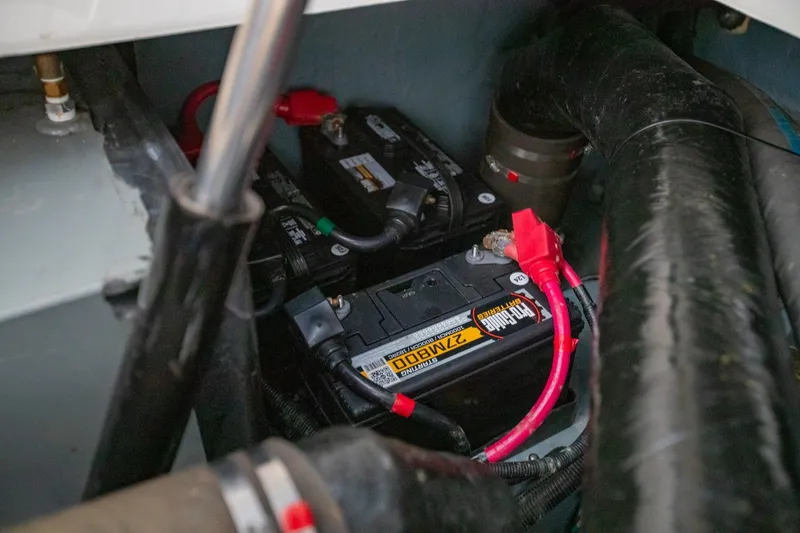 Slide: The Image of Battery compartment of a 2001 Sea Ray Sundancer 310 boat, featuring wiring and connections. - 34