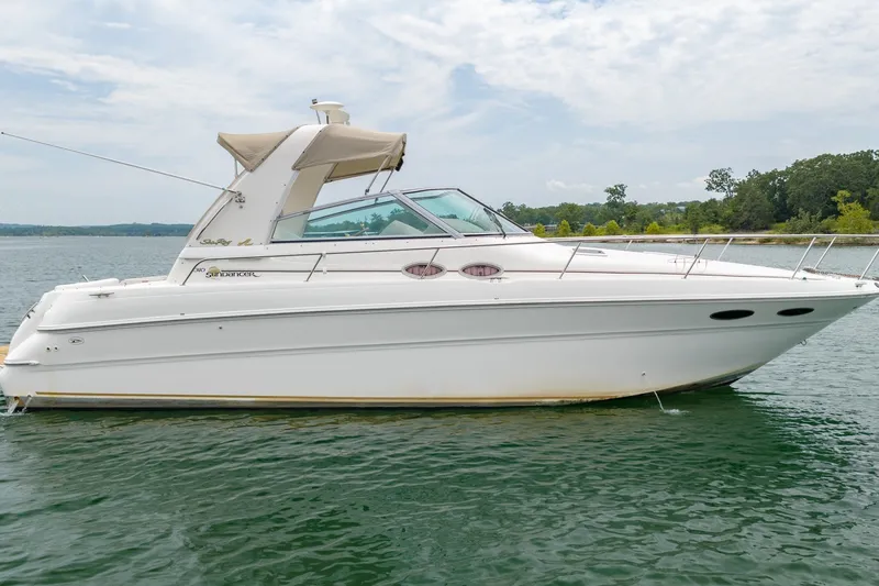 Slide: The Image of 2001 Sea Ray Sundancer 310 boat on a calm lake under a cloudy sky. - 6