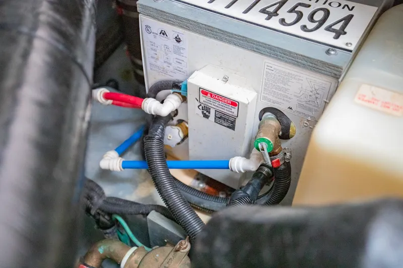 Slide: The Image of Engine compartment of a 2001 Sea Ray Sundancer 310 with visible wiring and components. - 37
