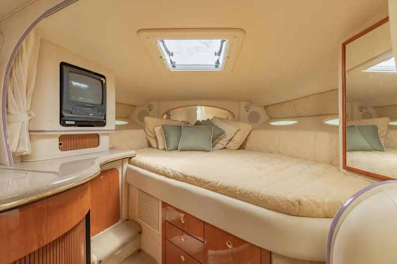 Slide: The Image of Luxurious interior cabin of 2001 Sea Ray Sundancer 310 yacht with cozy bedding and TV. - 30