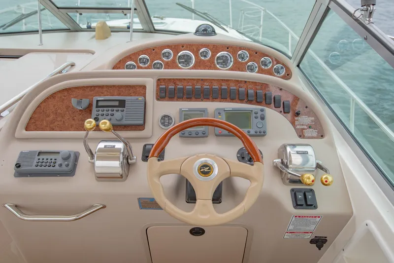 Slide: The Image of Cockpit of 2001 Sea Ray Sundancer 310 with steering wheel and control panels. - 16