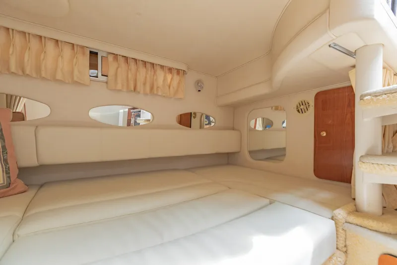 Slide: The Image of Interior cabin of 2001 Sea Ray Sundancer 310, featuring cozy seating and elegant design. - 24