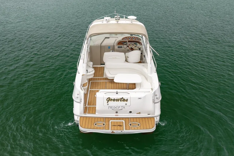 Slide: The Image of 2001 Sea Ray Sundancer 310 yacht on water, rear view with teak deck. - 4