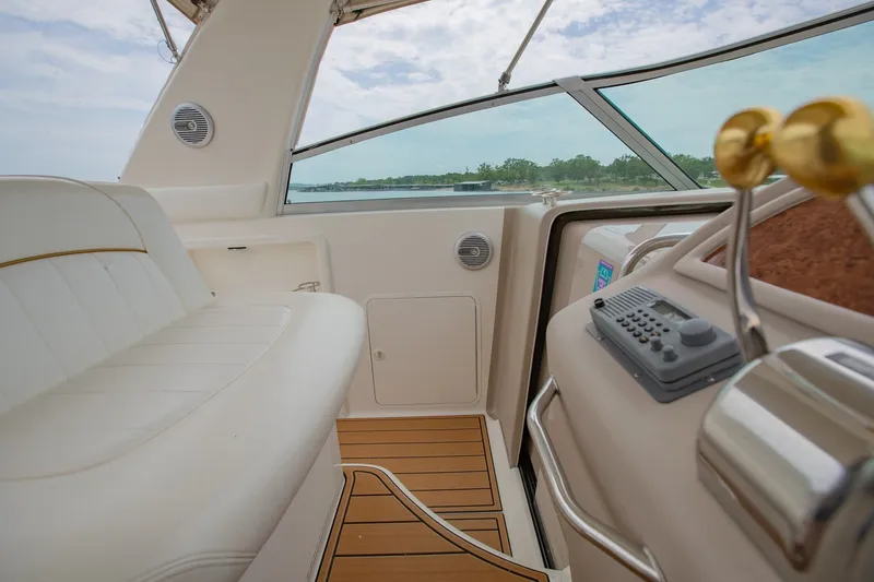 Slide: The Image of Interior view of 2001 Sea Ray Sundancer 310 boat with white seating and control panel. - 14