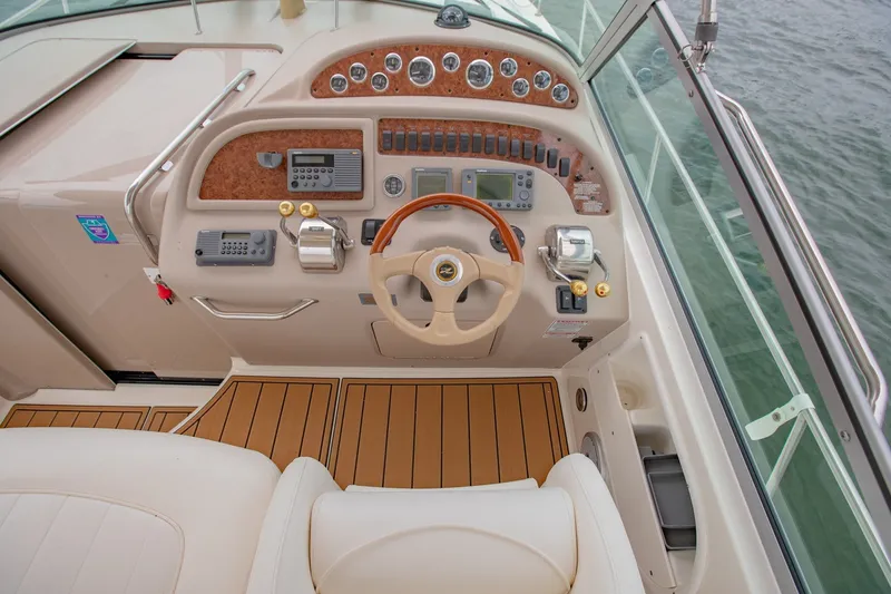 Slide: The Image of Cockpit of 2001 Sea Ray Sundancer 310 with steering wheel and control panel. - 15