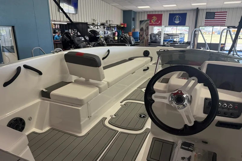 Slide: The Image of 2027 Tahoe T18 boat interior with steering wheel and seating in showroom. - 4