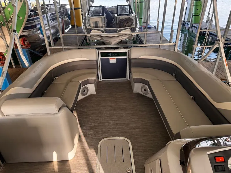 Slide: The Image of The image shows the interior of a 2023 Bennington 23SXSB pontoon boat with comfortable seating. - 5