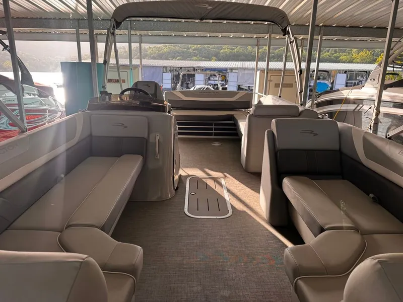 Slide: The Image of The image shows the interior of a 2023 Bennington 23SXSB pontoon boat with gray seating. - 4