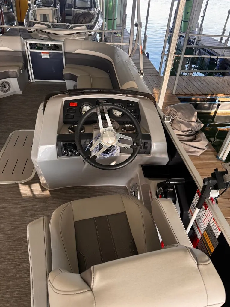 Slide: The Image of The image shows the cockpit of a 2023 Bennington 23SXSB with a modern steering wheel and comfortable seating. - 6