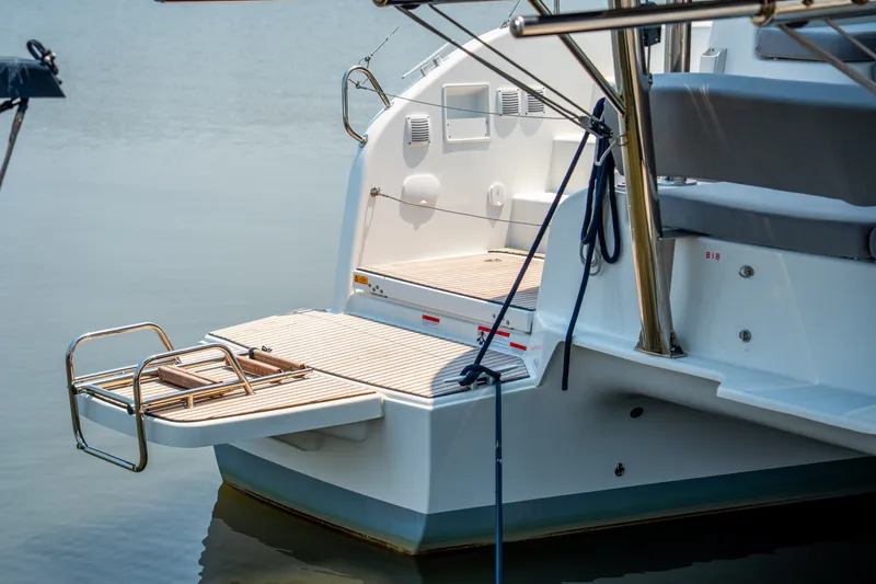 Slide: The Image of Stern view of 2026 Lagoon 38 catamaran with swim platform and ladder. - 31