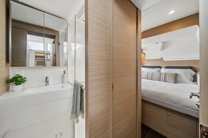 Slide: The Image of Modern interior of 2026 Lagoon 38 yacht featuring a cozy bedroom and sleek bathroom. - 73