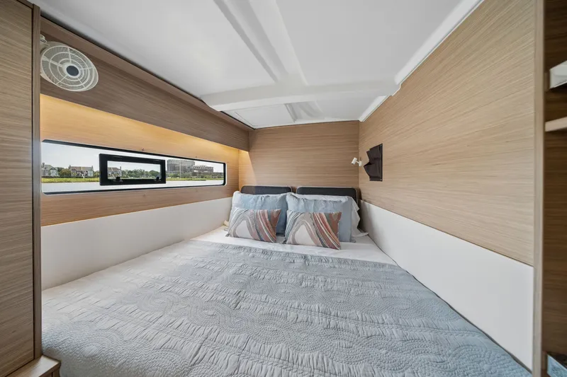 Slide: The Image of Cozy bedroom interior of 2026 Lagoon 38 yacht with modern design and large window. - 67