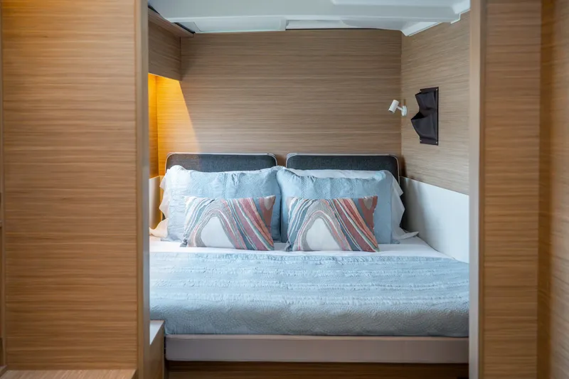 Slide: The Image of Luxurious cabin interior of 2026 Lagoon 38 yacht with cozy bedding and modern lighting. - 66