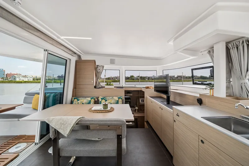 Slide: The Image of Modern interior of 2026 Lagoon 38 catamaran with spacious kitchen and dining area. - 60