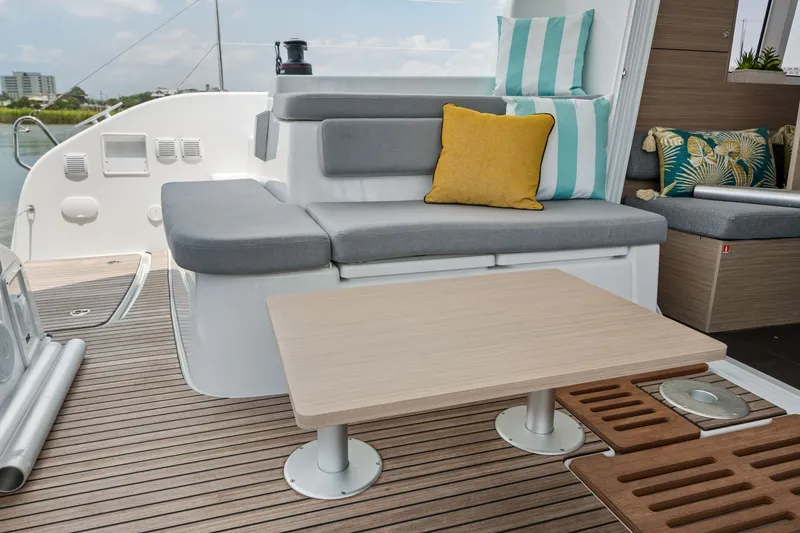 Slide: The Image of Luxurious seating area on 2026 Lagoon 38 yacht with stylish cushions and wooden table. - 54