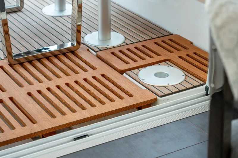 Slide: The Image of Luxurious teak deck flooring on 2026 Lagoon 38 yacht, featuring sleek metal accents. - 51