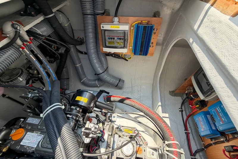 Slide: The Image of Engine room of a 2026 Lagoon 38 catamaran with electrical components and wiring. - 119